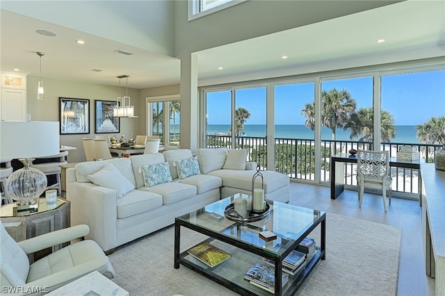 living room with hardwood / wood-style floors and a water view