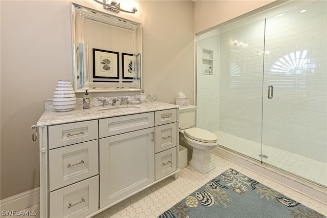 bathroom with a shower with door, toilet, vanity with extensive cabinet space, and tile flooring