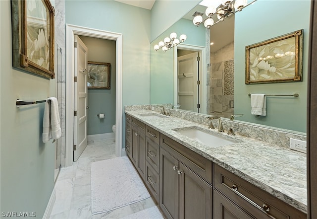 bathroom with tile floors, toilet, and dual vanity