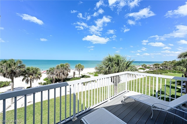 deck with a yard and a water view