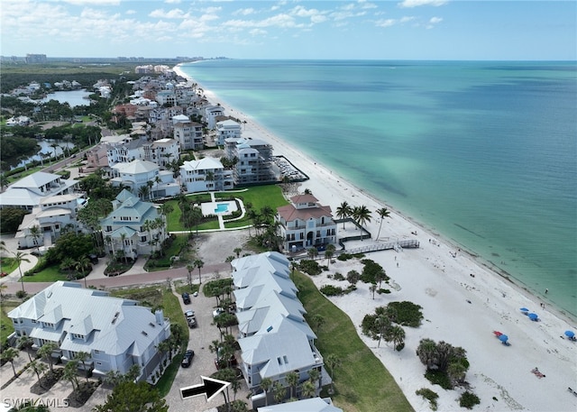 drone / aerial view featuring a beach view and a water view