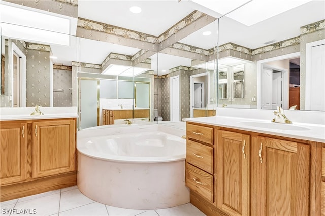 bathroom with a skylight, tile patterned flooring, vanity, and shower with separate bathtub