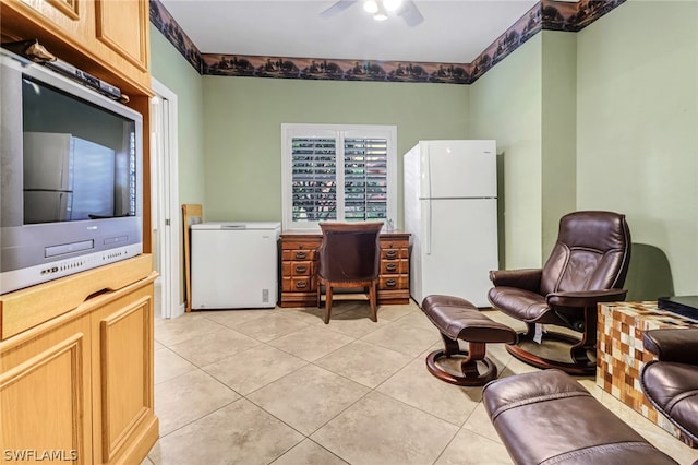 tiled office space featuring ceiling fan