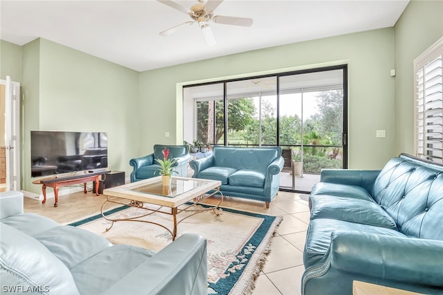 living room with ceiling fan, plenty of natural light, and light tile patterned flooring