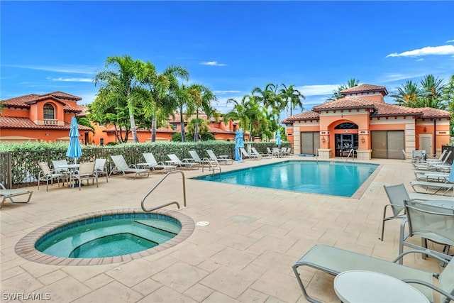 view of pool with a community hot tub and a patio