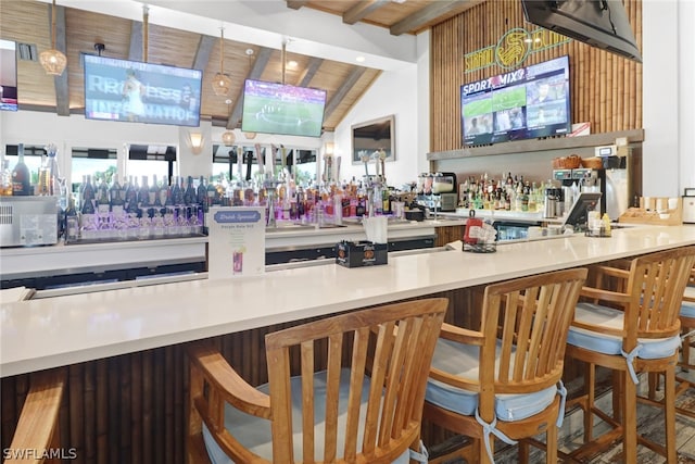 bar featuring lofted ceiling with beams, hanging light fixtures, and wooden ceiling