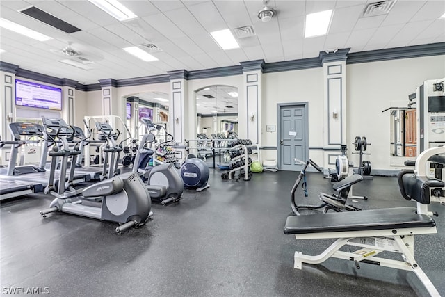 gym with a drop ceiling and crown molding