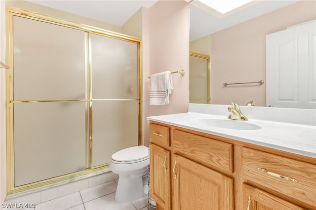 bathroom featuring tile patterned floors, vanity, toilet, and an enclosed shower