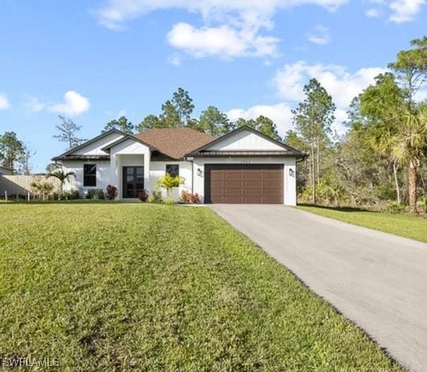 view of front of home featuring a garage and a front yard