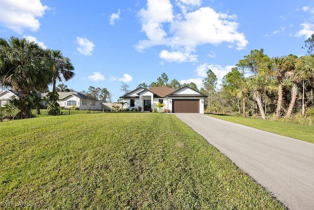 single story home featuring a garage and a front yard