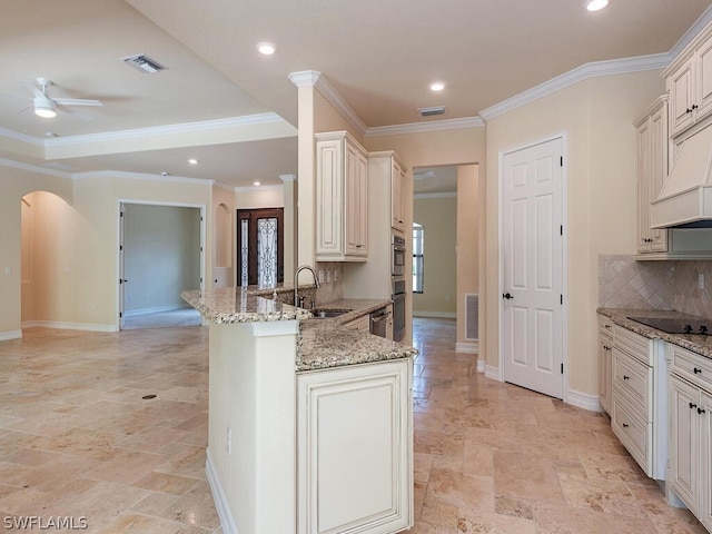 kitchen with sink, ornamental molding, kitchen peninsula, light stone counters, and decorative backsplash