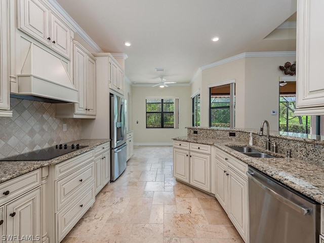 kitchen featuring a healthy amount of sunlight, stainless steel appliances, and light stone countertops