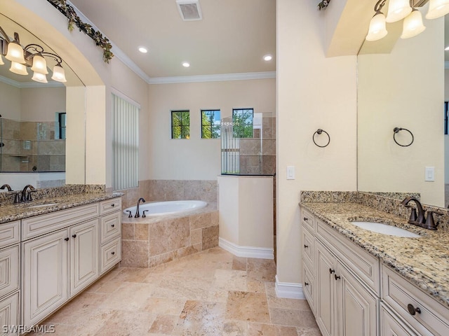 bathroom featuring vanity, ornamental molding, and tiled tub