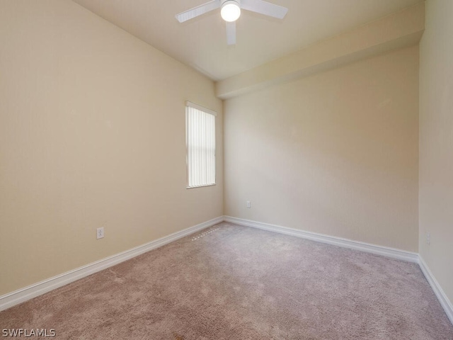 carpeted spare room featuring ceiling fan