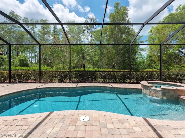 view of pool with an in ground hot tub, a patio, and a lanai