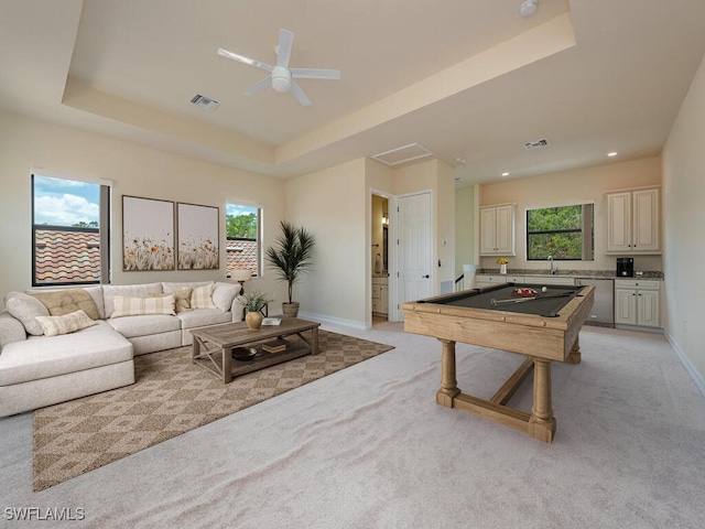 interior space with ceiling fan, a raised ceiling, pool table, and light colored carpet