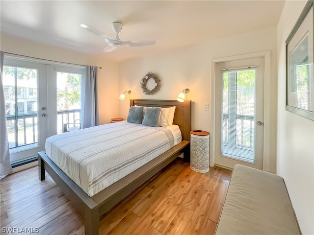 bedroom featuring wood-type flooring, multiple windows, french doors, and access to exterior