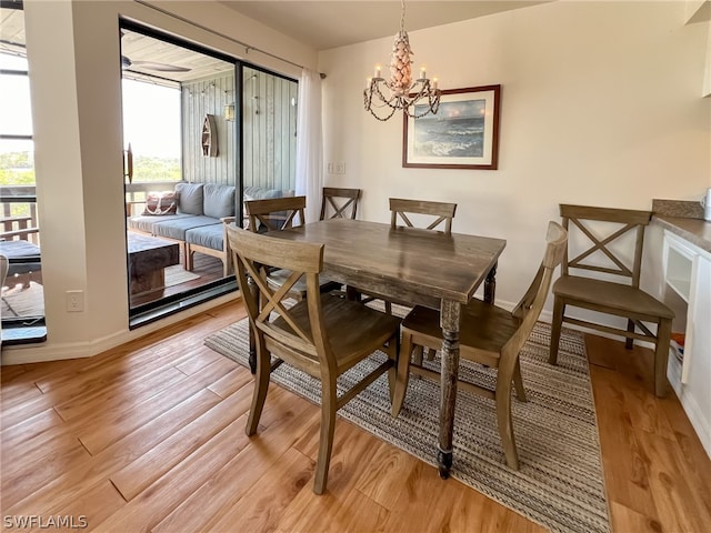 dining room with light hardwood / wood-style floors and a chandelier