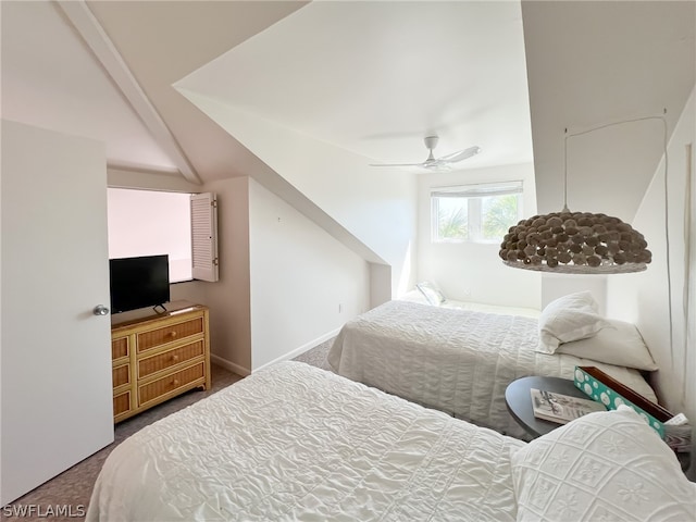 carpeted bedroom with ceiling fan and vaulted ceiling