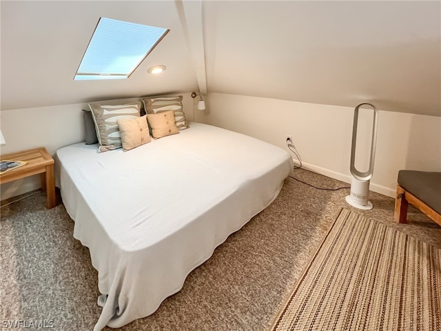 bedroom featuring lofted ceiling with skylight and carpet flooring