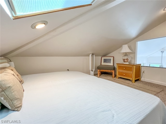 carpeted bedroom with vaulted ceiling