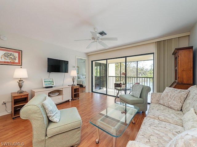 living room featuring hardwood / wood-style floors and ceiling fan