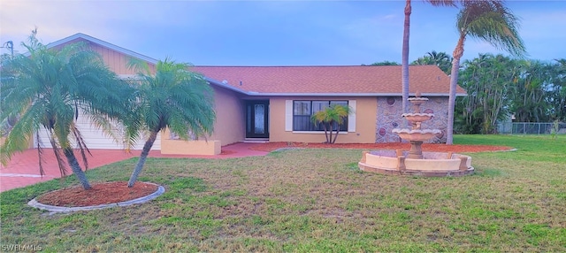 rear view of house featuring a yard