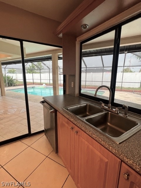 kitchen with plenty of natural light, sink, light tile floors, and stainless steel dishwasher