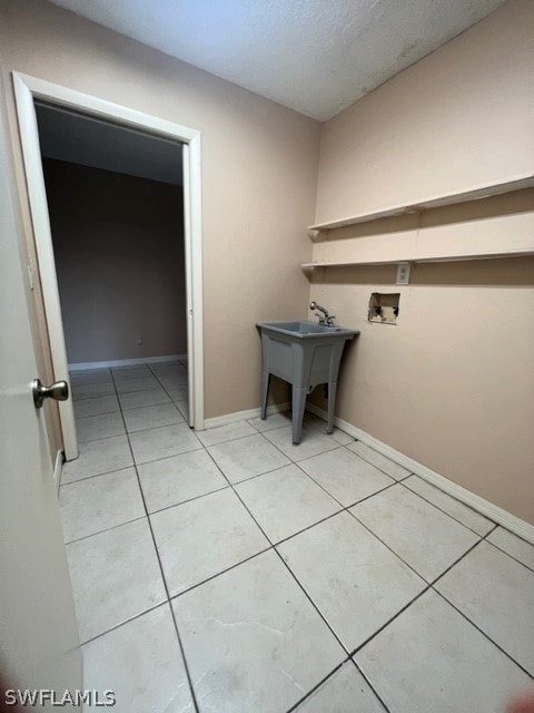 laundry area featuring washer hookup and light tile flooring