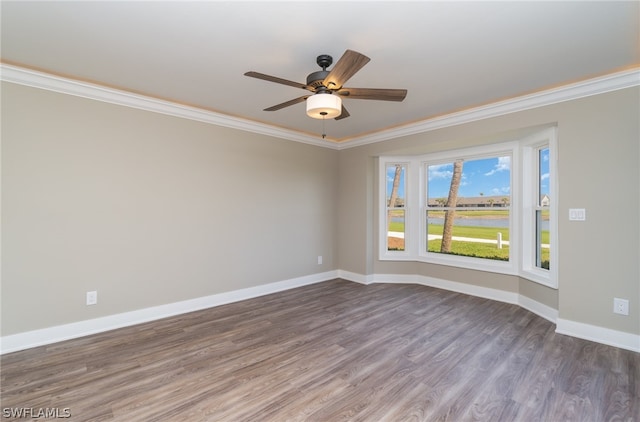 spare room with wood-type flooring, ceiling fan, and crown molding