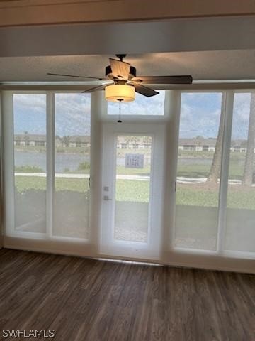 unfurnished sunroom featuring ceiling fan