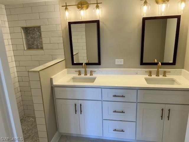 bathroom featuring dual sinks and vanity with extensive cabinet space