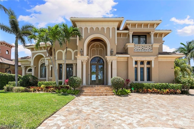 mediterranean / spanish-style house with french doors and a front yard