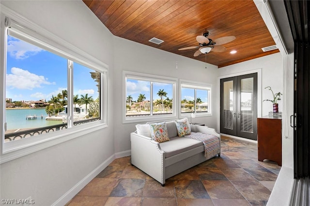 sunroom / solarium with ceiling fan, a water view, french doors, and wood ceiling