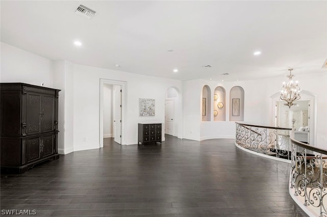 living room with dark hardwood / wood-style floors and a chandelier