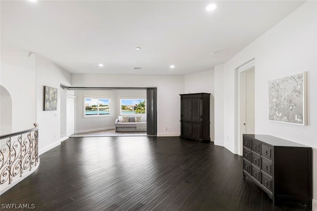 unfurnished living room with dark wood-type flooring