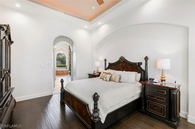 bedroom with ceiling fan and dark hardwood / wood-style flooring