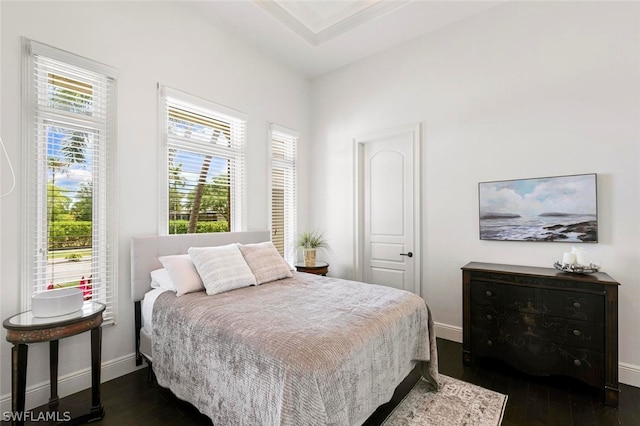 bedroom with dark wood-type flooring