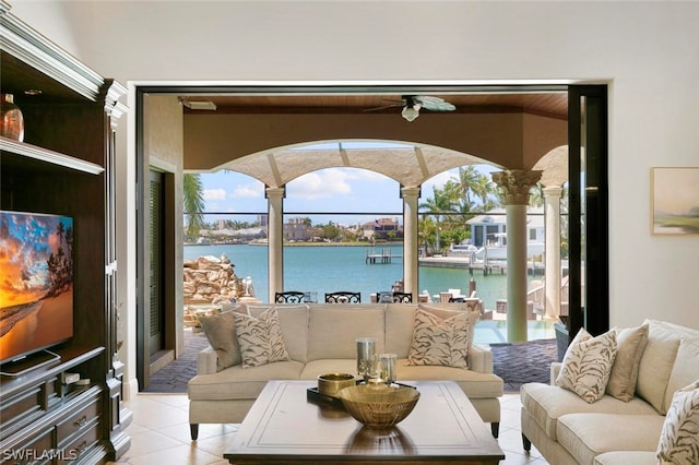 living room with a water view and light tile floors