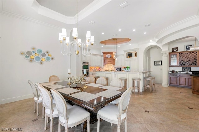 tiled dining area featuring ornamental molding and a raised ceiling