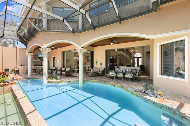 view of pool with outdoor lounge area, ceiling fan, and a patio