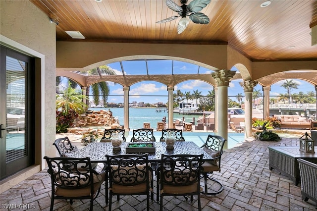 view of terrace with a water view and ceiling fan