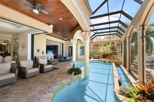 view of pool with a patio, an outdoor living space, a lanai, and ceiling fan