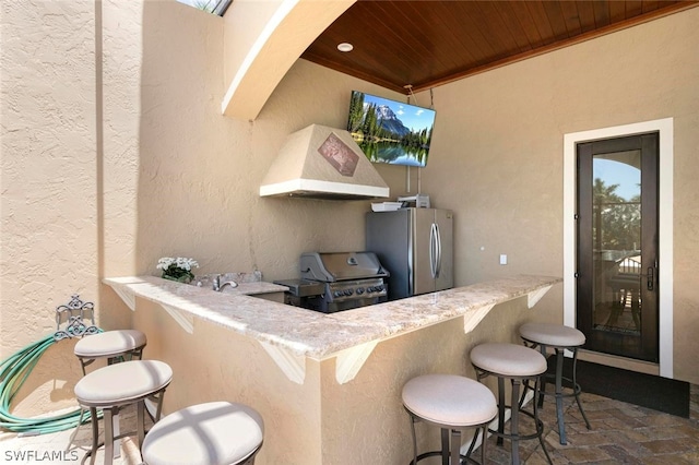 view of terrace with an outdoor kitchen, an outdoor bar, and grilling area