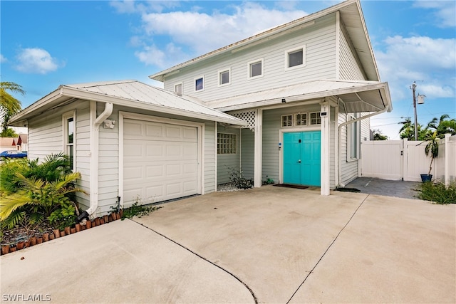 view of front of house featuring a garage and an outdoor structure