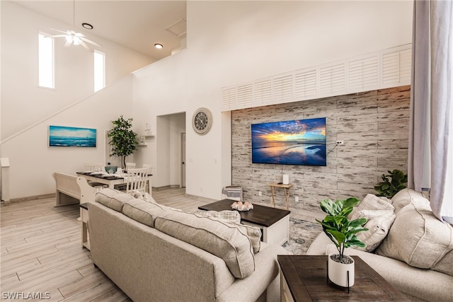 living room featuring a towering ceiling and ceiling fan