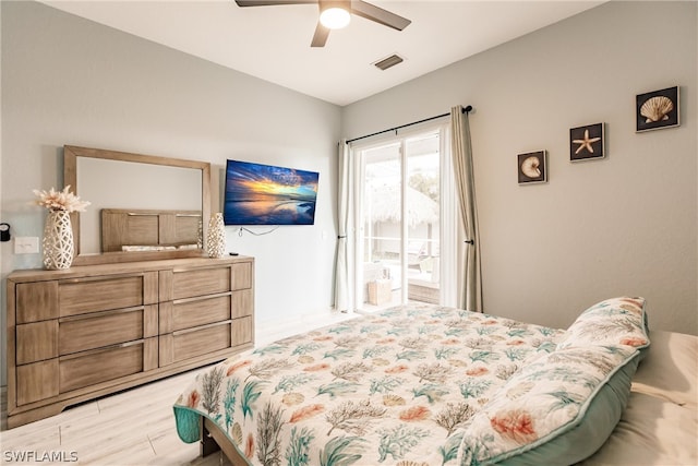 bedroom with hardwood / wood-style floors, ceiling fan, and access to outside