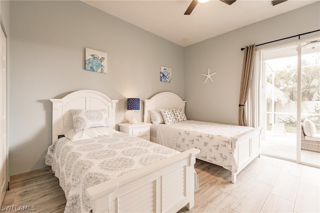 bedroom featuring light hardwood / wood-style floors, ceiling fan, and access to exterior