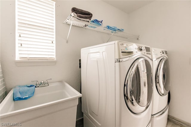 clothes washing area featuring separate washer and dryer