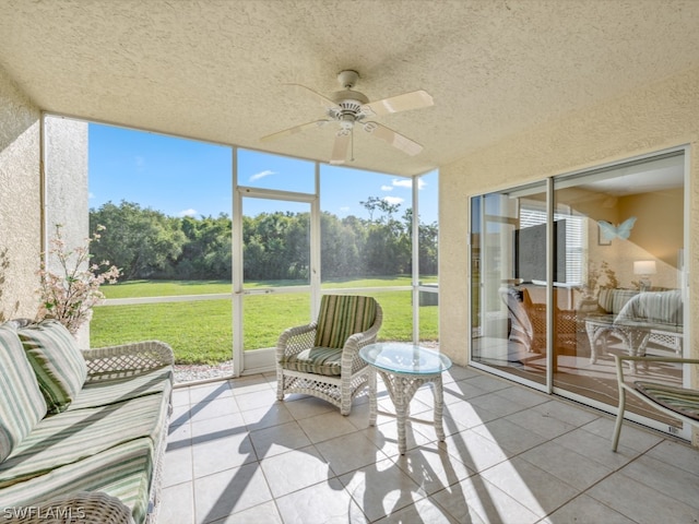 sunroom featuring ceiling fan